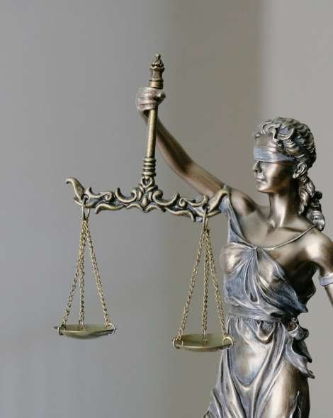 woman in dress holding sword figurine